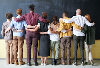 group of diverse individuals facing away from camera