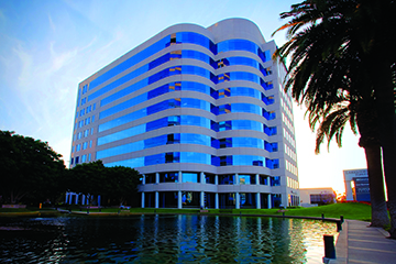 The Irvine campus building in front of water