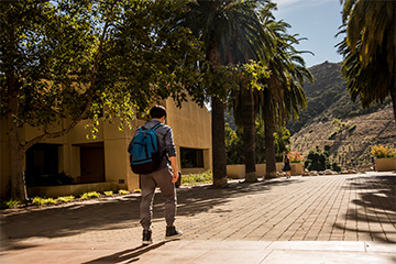 Student walks on GSEP Malibu campus on a sunny day.