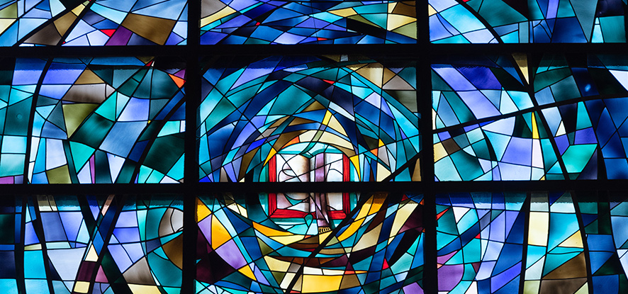 Close view of the center stain glass chapel window.