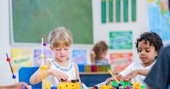 Children playing with toys in classroom