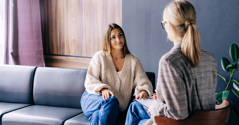 young female taking part in a therapy session with her female therapist