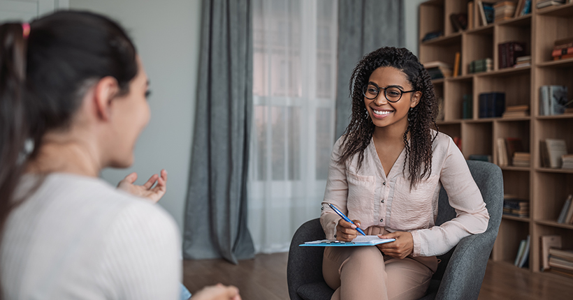 young female therapist talking to client