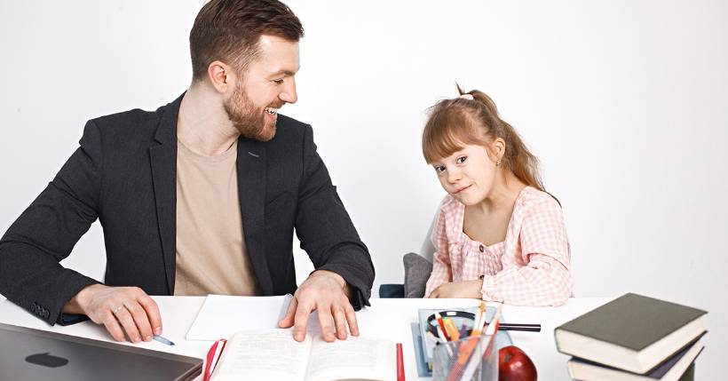 Young girl learning from her teacher