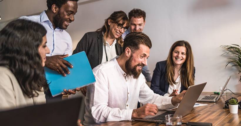 Group of people working together at a computer