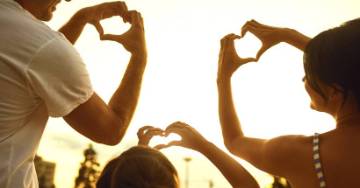 Family making hearts with their hands