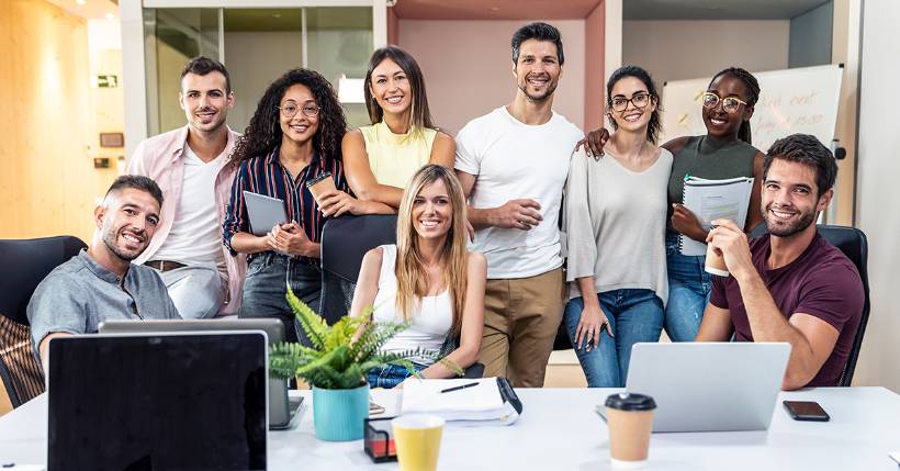 Group of people all standing together smiling