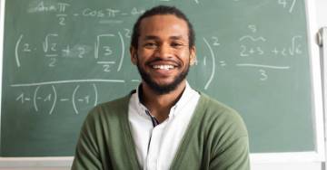 Teacher standing in front of chalkboard