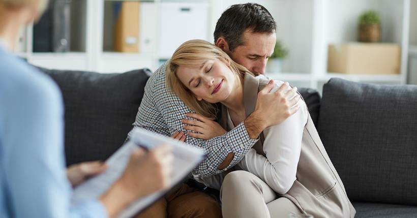 Couple embracing during a marriage therapy session