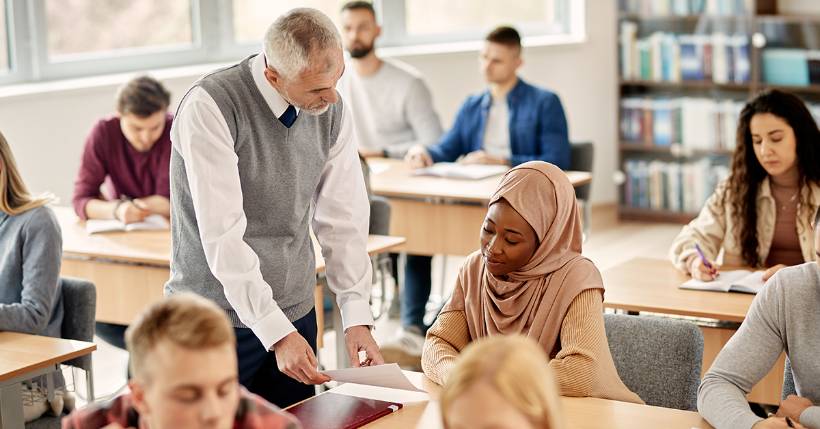 Teacher speaking to student regarding assignment.