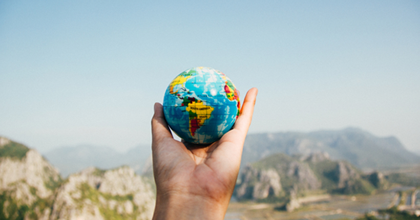 Hand holding a miniature globe