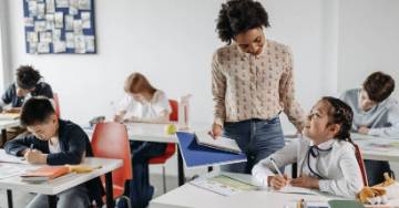 Teacher helping her student with schoolwork