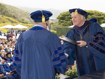 Pepperdine Phd Student receiving degree at Commencement.