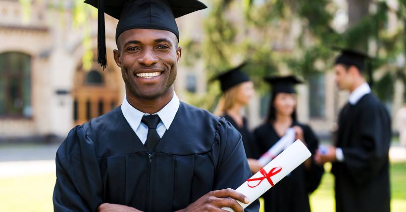 Graduate holding diploma