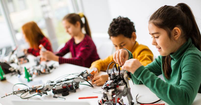 Young students building mechanical robots