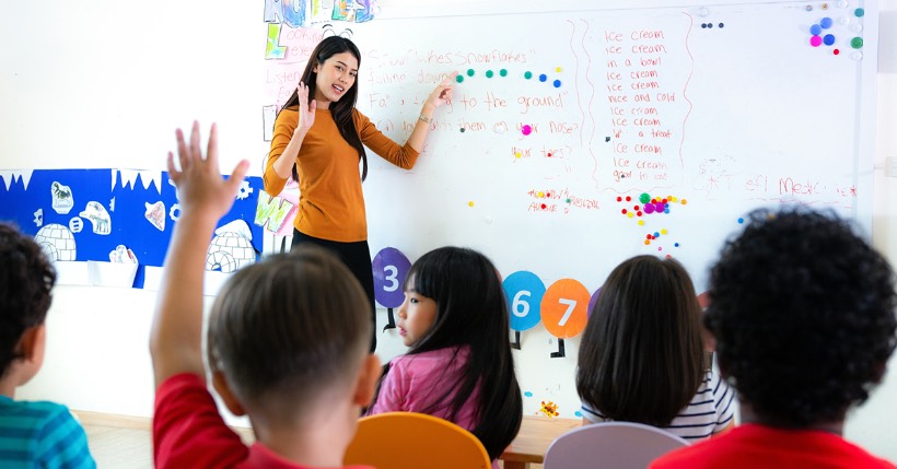 teacher at whiteboard in classroom