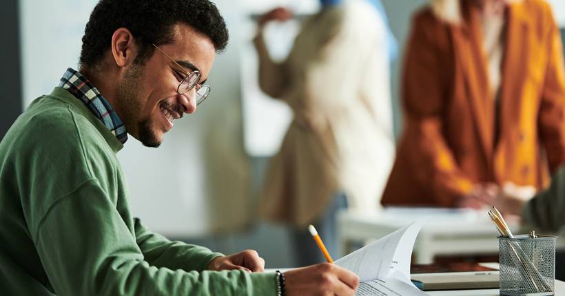 Man working at a desk smiling