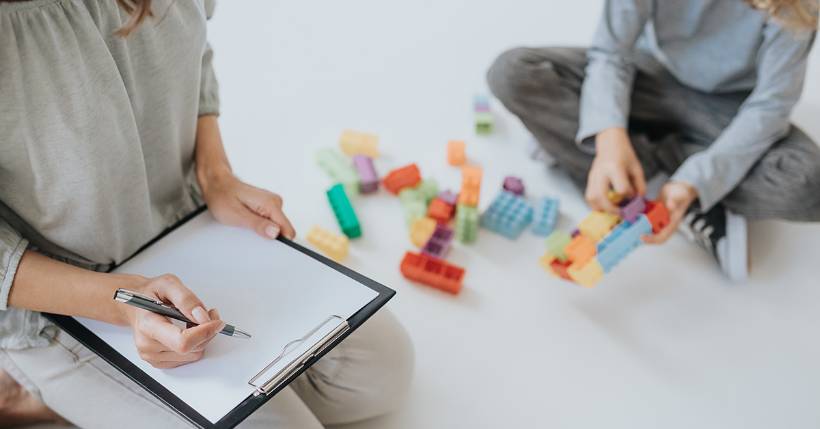 Therapist working with a child who is playing with blocks