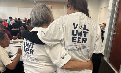 Nataliane and nora hugging with volunteer shirts on 