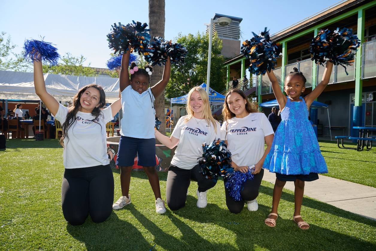 Pepperdine cheerleaders with kids