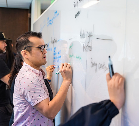 TESOL student writing on whiteboard