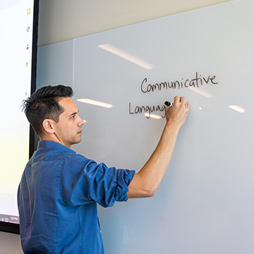 professor writing on a whiteboard