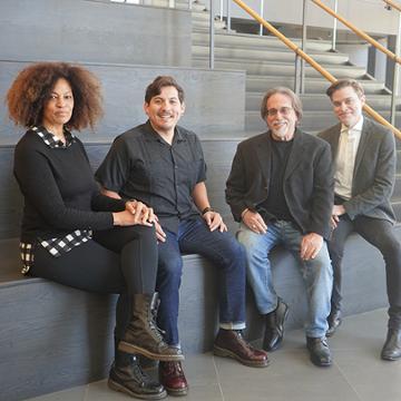 Dr. David A. Levy sitting with the scholarship winners