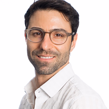 Headshot of Kfir Mordechay in a white button up shirt