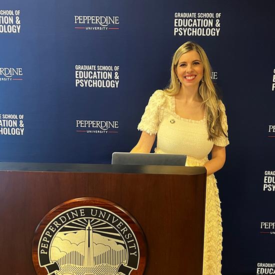 Dr. Lauren Cook standing behind a podium 