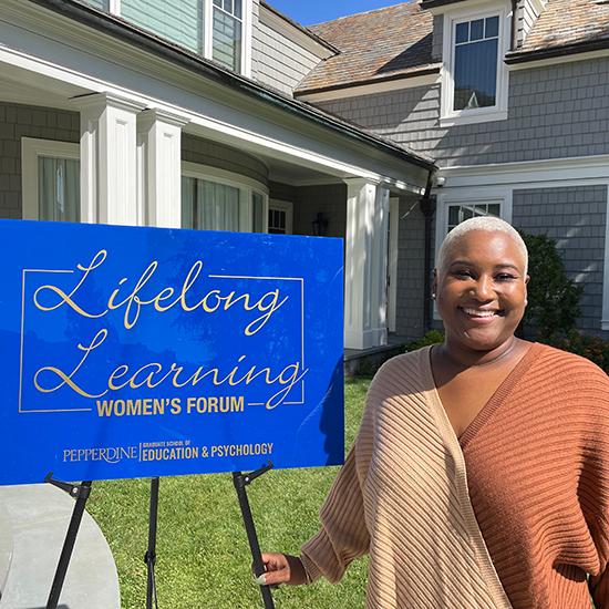 Dr. Nicole Johnson standing next to the Lifelong Learning Women's Forum logo.