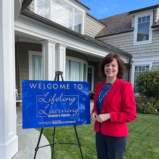 Dr. Heather Backstrom posing outside the Lifelong Learning Women's Forum location 