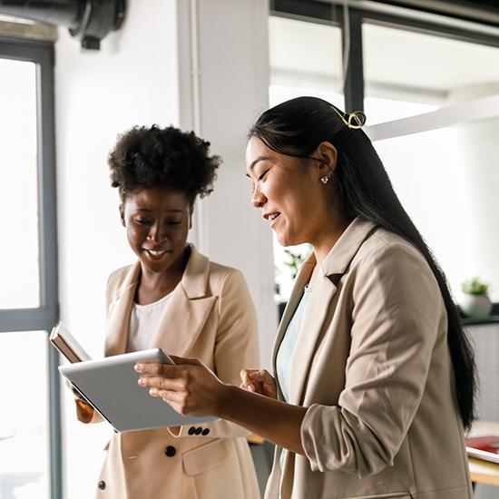 two young businesswomen discussing a work project